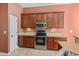Well-equipped kitchen showcasing modern appliances, tiled floors, wooden cabinets and ample counter space at 56 Willowbend Dr., Murrells Inlet, SC 29576