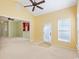 Inviting living room with high ceilings, ceiling fan, a large window, tile entryway, and neutral wall color at 56 Willowbend Dr., Murrells Inlet, SC 29576