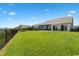 Expansive backyard featuring a lush lawn, black metal fence, and a patio area perfect for outdoor gatherings at 567 Hickman St., Myrtle Beach, SC 29575