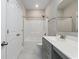 Clean bathroom with white tiled floors, gray vanity and large mirror, featuring a shower-tub combo at 567 Hickman St., Myrtle Beach, SC 29575