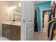 Bright bathroom featuring double vanity, framed mirror, decorative lighting and fixtures, with access to closet at 567 Hickman St., Myrtle Beach, SC 29575