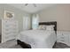 Bright bedroom featuring a neutral color palette, a large bed, bedside table, and a dresser with a mirror at 567 Hickman St., Myrtle Beach, SC 29575
