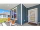 Inviting front porch with comfortable seating and a view of the well-maintained lawn and blue-sided home at 567 Hickman St., Myrtle Beach, SC 29575