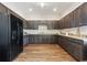 Stylish kitchen boasting sleek black appliances, granite countertops, and dark wood cabinetry at 567 Hickman St., Myrtle Beach, SC 29575