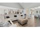 Open-concept living area with a large sofa, hardwood floors, and a seamless flow into the kitchen and dining spaces at 567 Hickman St., Myrtle Beach, SC 29575