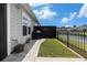 A backyard features a grill, a lawn, and a view of the neighborhood pond at 5826 Cremona Dr., Myrtle Beach, SC 29577