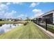 This backyard with a pond is bordered by a sleek black fence at 5826 Cremona Dr., Myrtle Beach, SC 29577
