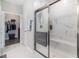 Modern bathroom featuring a walk-in shower with glass enclosure, marble-style tile, and a convenient bench seat at 5826 Cremona Dr., Myrtle Beach, SC 29577