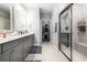 Elegant bathroom with double vanity, modern fixtures, and a glass-enclosed shower with marble-style tile at 5826 Cremona Dr., Myrtle Beach, SC 29577