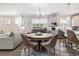 Bright dining area featuring a round table, stylish chairs, and decorative accents, adjacent to the modern kitchen at 5826 Cremona Dr., Myrtle Beach, SC 29577