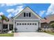 Attached two-car garage with flowerpots and an American flag at 5826 Cremona Dr., Myrtle Beach, SC 29577