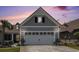 Attached two-car garage with flowerpots and an American flag at 5826 Cremona Dr., Myrtle Beach, SC 29577