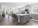 Open-concept kitchen featuring a gray island, pendant lights, and seamless flow into the living and dining areas at 5826 Cremona Dr., Myrtle Beach, SC 29577