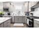 Modern kitchen with stainless steel appliances, white countertops, and sleek gray cabinetry at 5826 Cremona Dr., Myrtle Beach, SC 29577