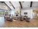 Inviting lounge area with high ceilings, exposed beams, a cozy fireplace, comfortable seating and wood-look floors at 5826 Cremona Dr., Myrtle Beach, SC 29577