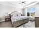 Comfortable main bedroom featuring a king-sized bed, a ceiling fan, and natural light at 5826 Cremona Dr., Myrtle Beach, SC 29577