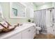 Well-lit bathroom features vanity with marble countertops and shower-tub combo at 6001-R11 S Kings Hwy., Myrtle Beach, SC 29575