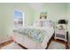 Cozy bedroom with natural light from a large window and a comfortable bed with decorative pillows and bedding at 6001-R11 S Kings Hwy., Myrtle Beach, SC 29575