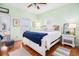 Inviting bedroom with hardwood floors, ceiling fan, and access to outdoor patio at 6001-R11 S Kings Hwy., Myrtle Beach, SC 29575