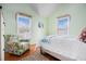 Bright bedroom features a large window and chair, creating a comfortable and inviting space at 6001-R11 S Kings Hwy., Myrtle Beach, SC 29575