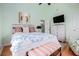 This bedroom features a plush bed with decorative pillows, TV, and an upholstered bench at 6001-R11 S Kings Hwy., Myrtle Beach, SC 29575