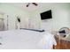 Relaxing bedroom features hardwood floors, ceiling fan, and dresser with mounted television at 6001-R11 S Kings Hwy., Myrtle Beach, SC 29575