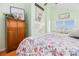 Cozy bedroom features hardwood floors and light green walls and a vintage wardrobe at 6001-R11 S Kings Hwy., Myrtle Beach, SC 29575