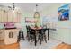Bright dining area featuring a stylish table set for six, complemented by elegant decor and natural light at 6001-R11 S Kings Hwy., Myrtle Beach, SC 29575