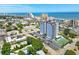Aerial view highlighting a condo building, tennis court, pool, parking, and nearby coastal cityscape at 601 Mitchell Dr. # 607, Myrtle Beach, SC 29577