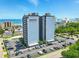 Exterior shot of Holiday Towers with ample parking, tennis court, and partial ocean view at 601 Mitchell Dr. # 607, Myrtle Beach, SC 29577