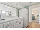 Bright kitchen with white cabinets and appliances, offering a glimpse into the living area and bedroom at 601 Mitchell Dr. # 607, Myrtle Beach, SC 29577