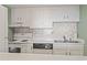 Well-equipped kitchen featuring white appliances, mosaic backsplash, and efficient layout at 601 Mitchell Dr. # 607, Myrtle Beach, SC 29577