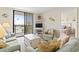 Well-lit living room with comfortable seating, balcony access, and a glimpse into the bedroom at 601 Mitchell Dr. # 607, Myrtle Beach, SC 29577