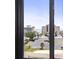 View from window showcasing parking lot, buildings, palm trees, and blue ocean at 601 Mitchell Dr. # 607, Myrtle Beach, SC 29577