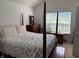 Cozy bedroom with a four-poster bed, vintage furniture, and natural light from the window at 62 4 Rye Grass Ln. # 4, Pawleys Island, SC 29585