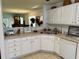 Well-lit kitchen featuring white cabinetry, neutral countertops, and a stainless steel sink at 62 4 Rye Grass Ln. # 4, Pawleys Island, SC 29585
