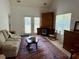 Comfortable living room with a sofa, TV cabinet, and stylish rug at 62 4 Rye Grass Ln. # 4, Pawleys Island, SC 29585
