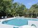 Inviting community pool area featuring clear blue water, lounge chairs, and lush landscaping for a relaxing outdoor experience at 62 4 Rye Grass Ln. # 4, Pawleys Island, SC 29585