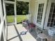 Inviting screened porch featuring comfortable seating and serene views of the surrounding landscape at 62 4 Rye Grass Ln. # 4, Pawleys Island, SC 29585