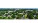Expansive aerial view of a lush, green neighborhood with mature trees, beautiful homes, and a skyline backdrop at 6210 Blynn Dr., Myrtle Beach, SC 29572