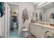 Bathroom featuring blue and white tiling, white cabinetry, and decorative accessories at 6210 Blynn Dr., Myrtle Beach, SC 29572