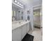 Bright bathroom features a white vanity, large mirror, and ample lighting at 6210 Blynn Dr., Myrtle Beach, SC 29572