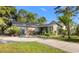 Charming single story home featuring a brick exterior and lush landscaping at 6210 Blynn Dr., Myrtle Beach, SC 29572