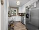 Well-lit kitchen featuring stainless steel appliances, white cabinets, and a large window at 6210 Blynn Dr., Myrtle Beach, SC 29572