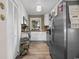 Charming kitchen with stainless steel refrigerator, white cabinets, and modern lighting at 6210 Blynn Dr., Myrtle Beach, SC 29572
