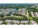 Extensive aerial of neighborhood with trees, houses, and a lake at 6253 Catalina Dr. # 1824, North Myrtle Beach, SC 29582