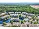 Aerial view of the community shows multiple buildings, surrounding trees and a community pool at 6253 Catalina Dr. # 1824, North Myrtle Beach, SC 29582