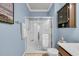 Bathroom with glass shower doors, dark wood vanity, blue walls, and chrome hardware at 6253 Catalina Dr. # 1824, North Myrtle Beach, SC 29582