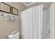 Bathroom with a shower/tub combination, featuring a white shower curtain and beige walls at 6253 Catalina Dr. # 1824, North Myrtle Beach, SC 29582