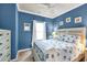 Nautical themed bedroom with blue walls, a ceiling fan, and a comfy bed at 6253 Catalina Dr. # 1824, North Myrtle Beach, SC 29582